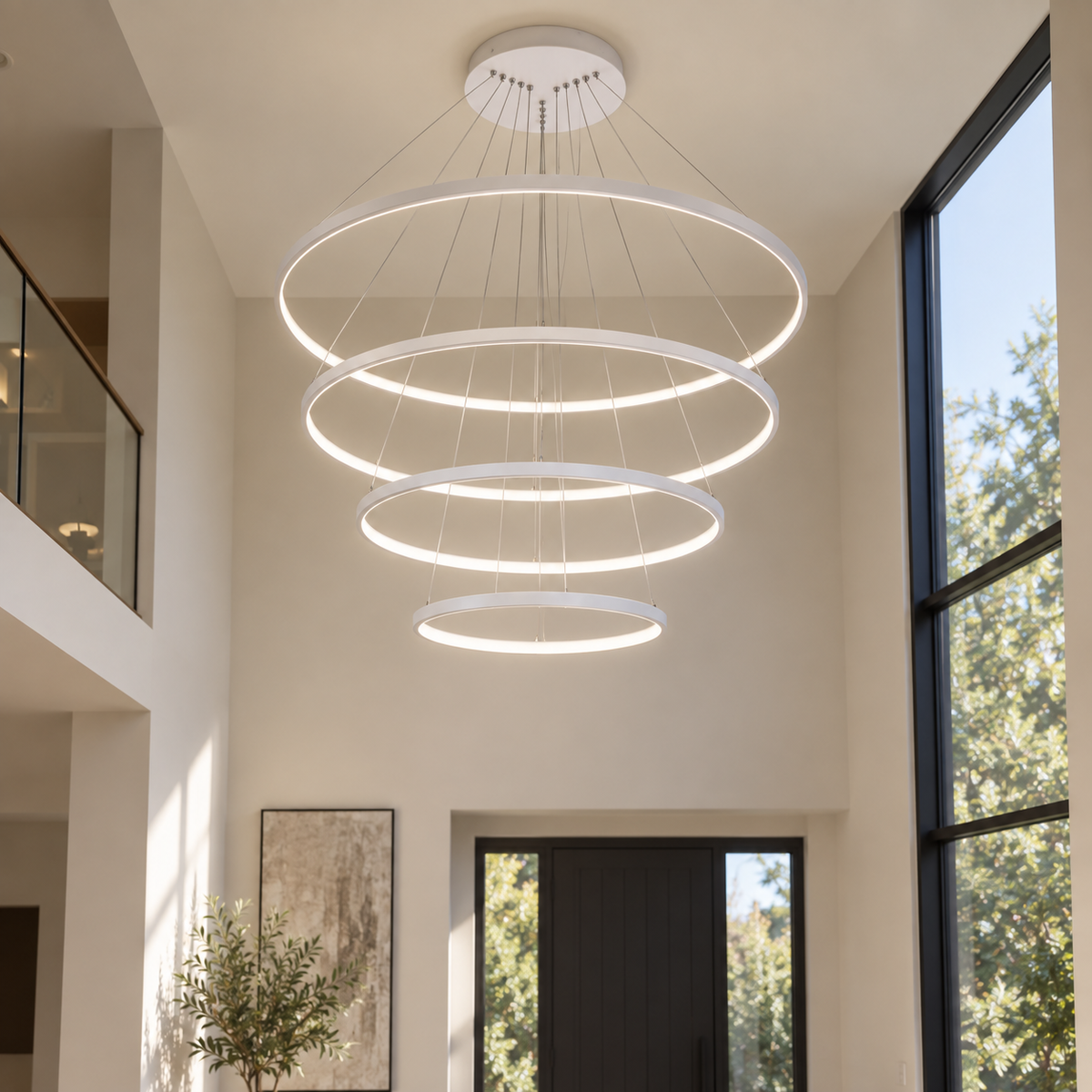 Aldwick white four-ring LED chandelier in a high-ceiling foyer