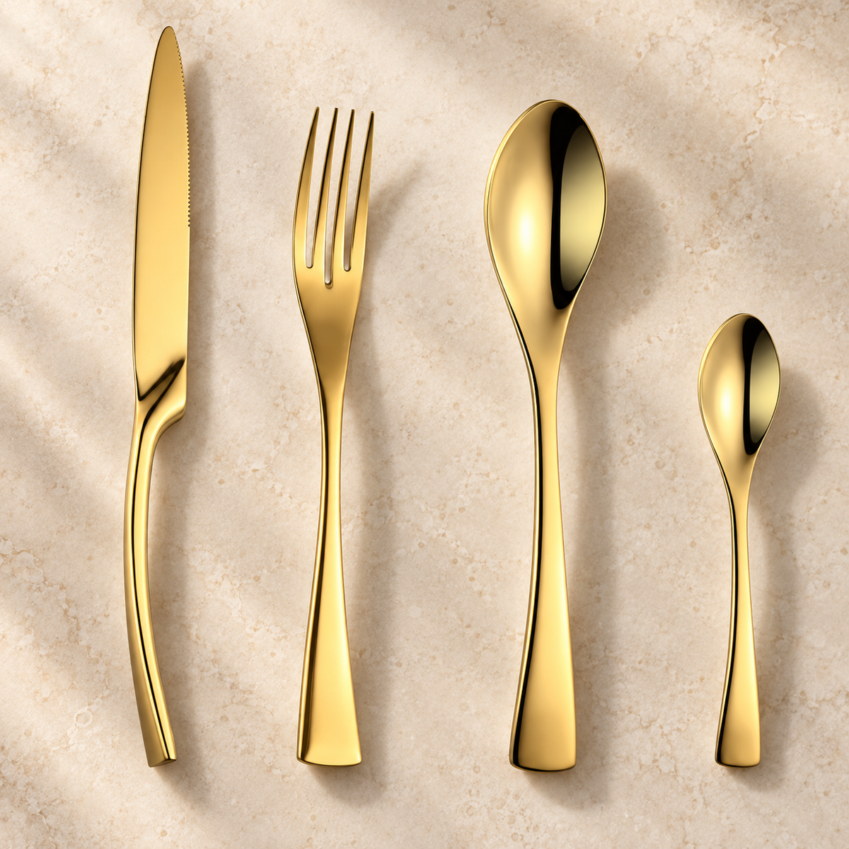 Eira gold stainless steel cutlery set with slim knife, fork, spoon, and teaspoon