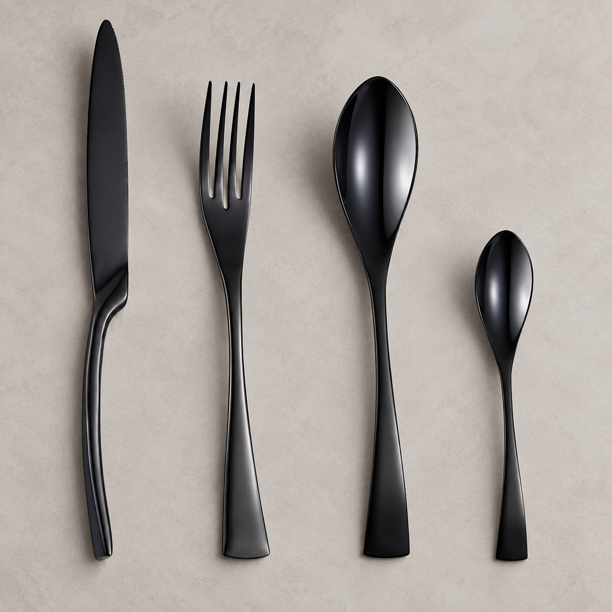 Eira black stainless steel cutlery set with slim knife, fork, spoon, and teaspoon