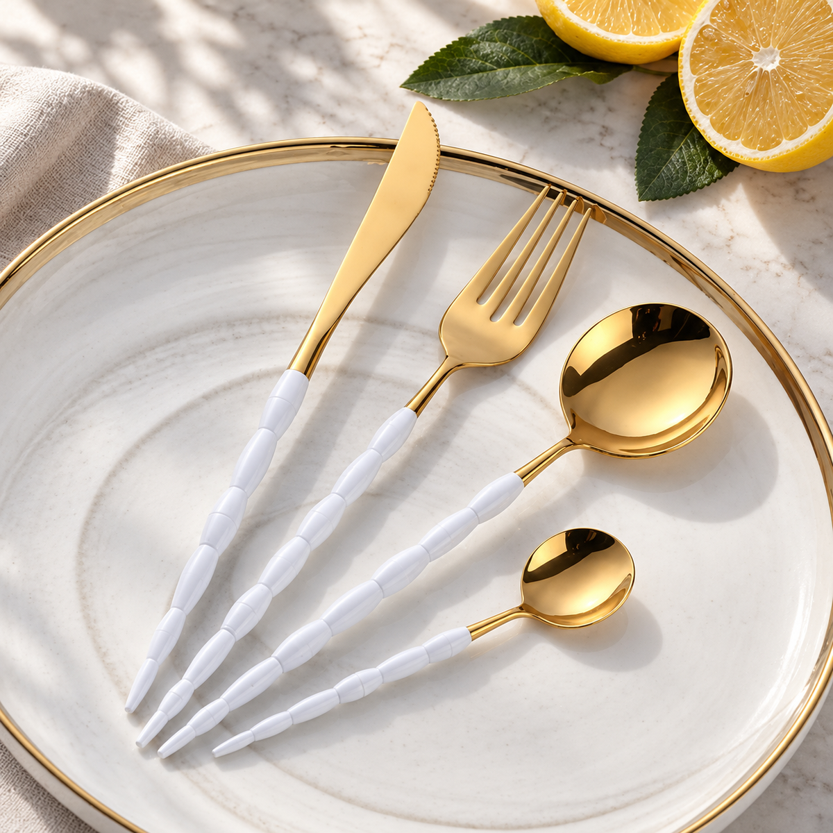 Nyland sculpted-handle cutlery set in White Gold on a white stoneware plate