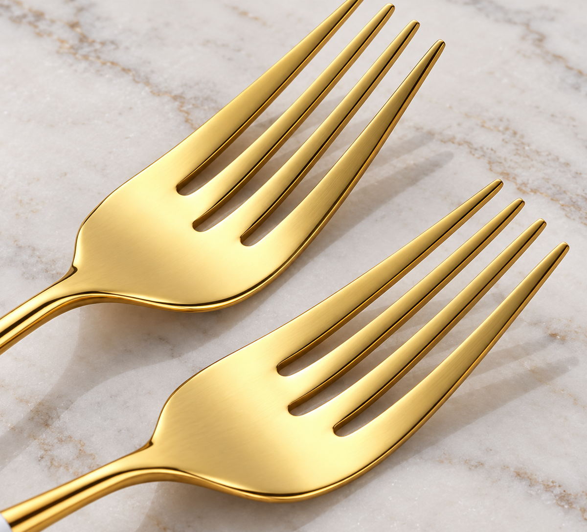 Nyland gold stainless-steel fork heads showing polished finish and four-tine design