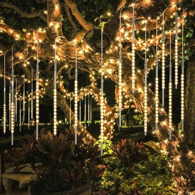 Warm white LED icicle tube lights hanging in a garden tree