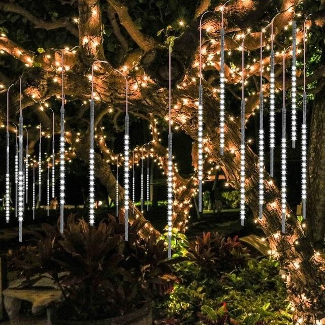 White LED icicle tube lights hanging in a garden tree