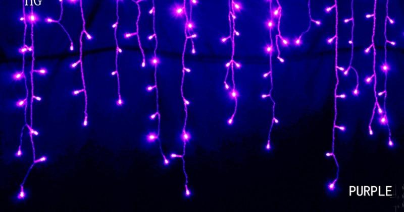 Ylva purple LED curtain string lights glowing against a dark background