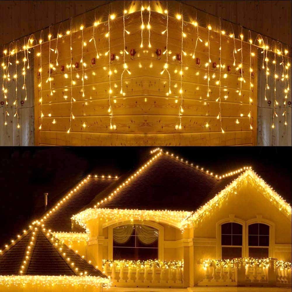Ylva warm white LED curtain lights across a winter house roofline and window