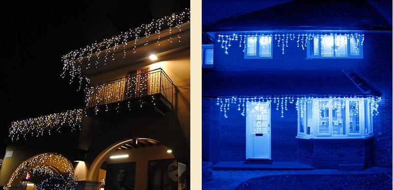 Ylva white LED curtain lights displayed on two house exteriors at night