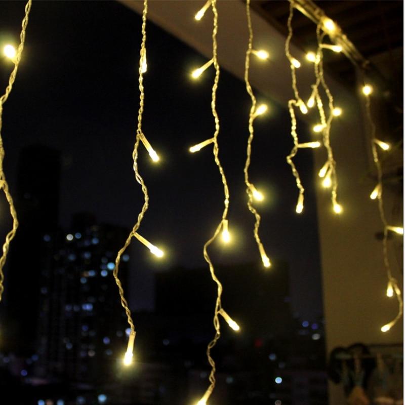 Ylva warm white LED curtain lights hanging on a balcony at night