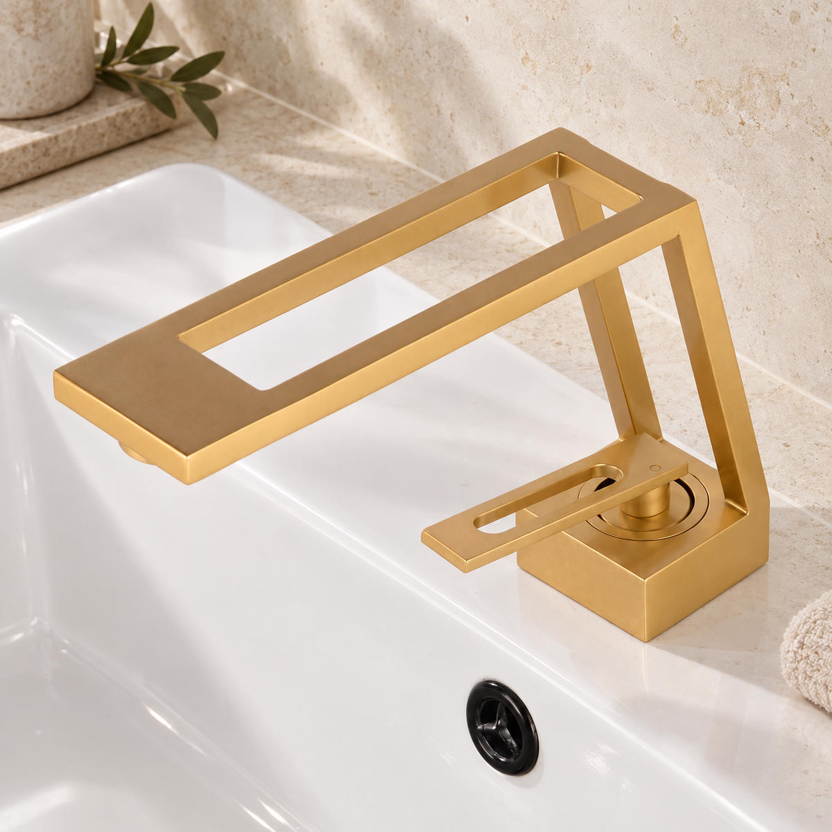 Gold cut-out basin tap installed on a white basin in warm natural light
