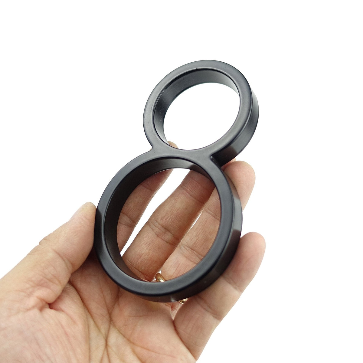 Black zinc alloy house number 8 held in hand to show size and finish