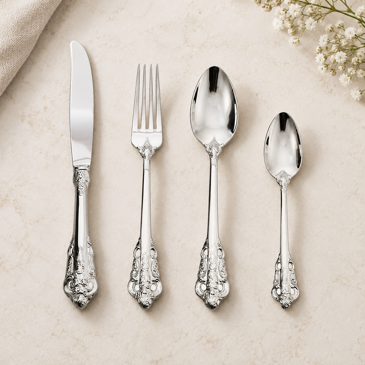 Solva silver vintage cutlery set with ornate handles on an ivory background