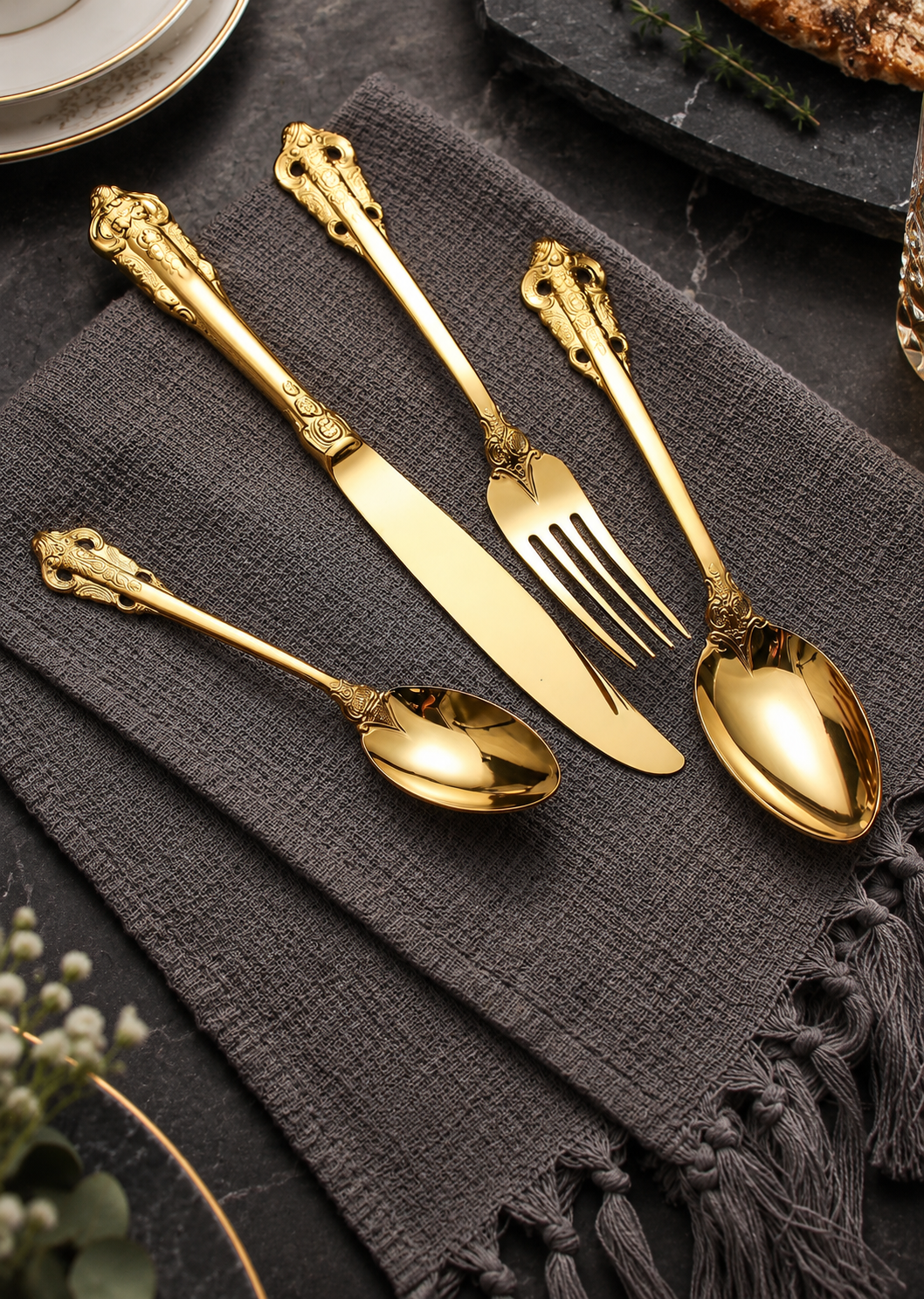 Solva gold vintage cutlery arranged on charcoal linen