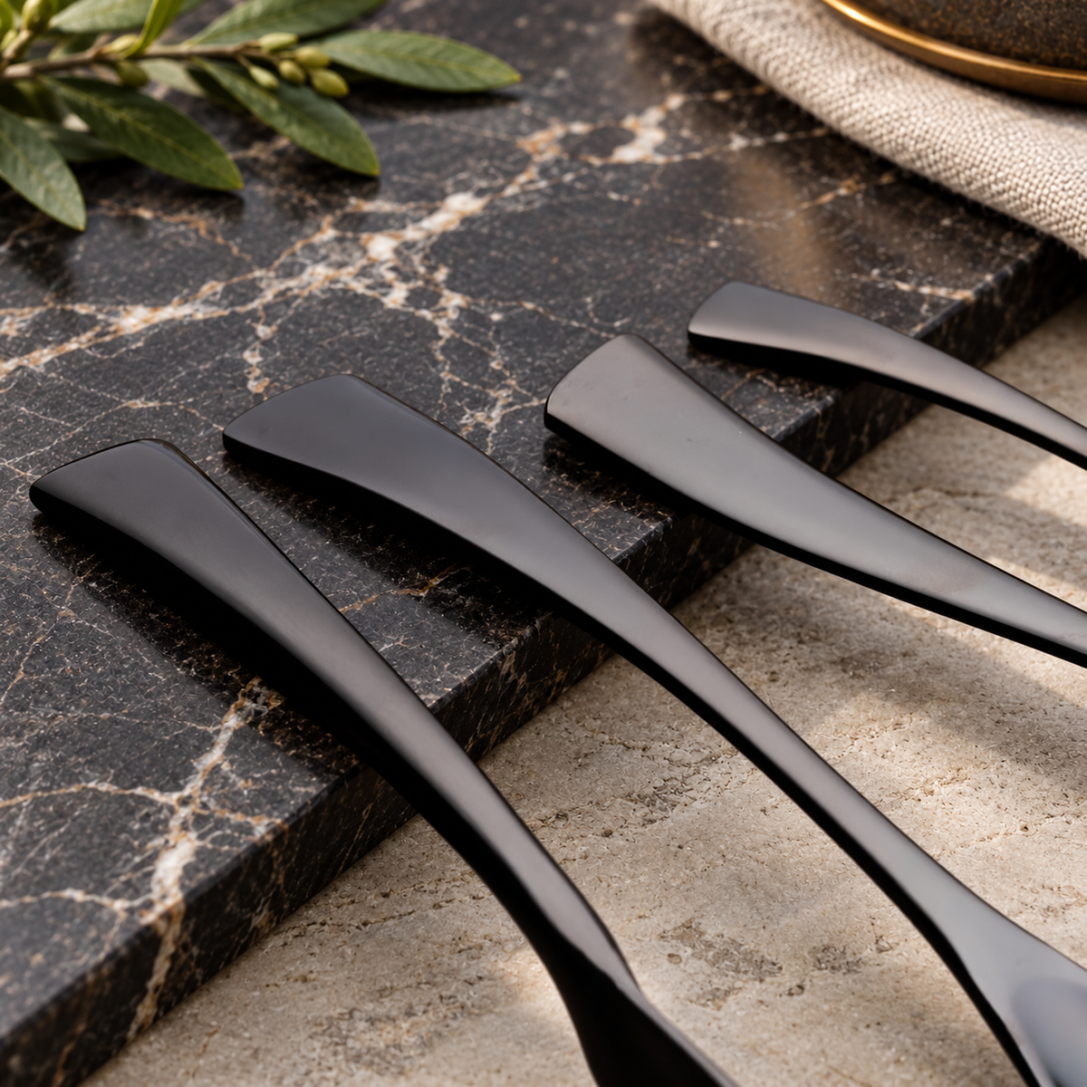 Vidar black metal cutlery handle detail on a dark stone surface