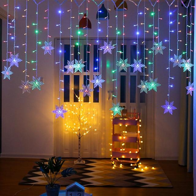 Torun snowflake LED string lights in colorful LEDs above a warm-lit living room