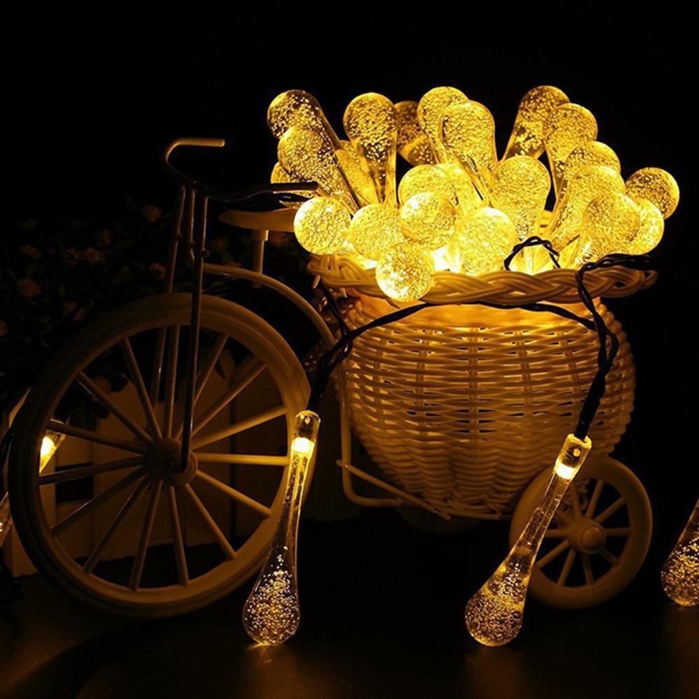 Sigrid warm white solar droplet string lights displayed in a bicycle basket