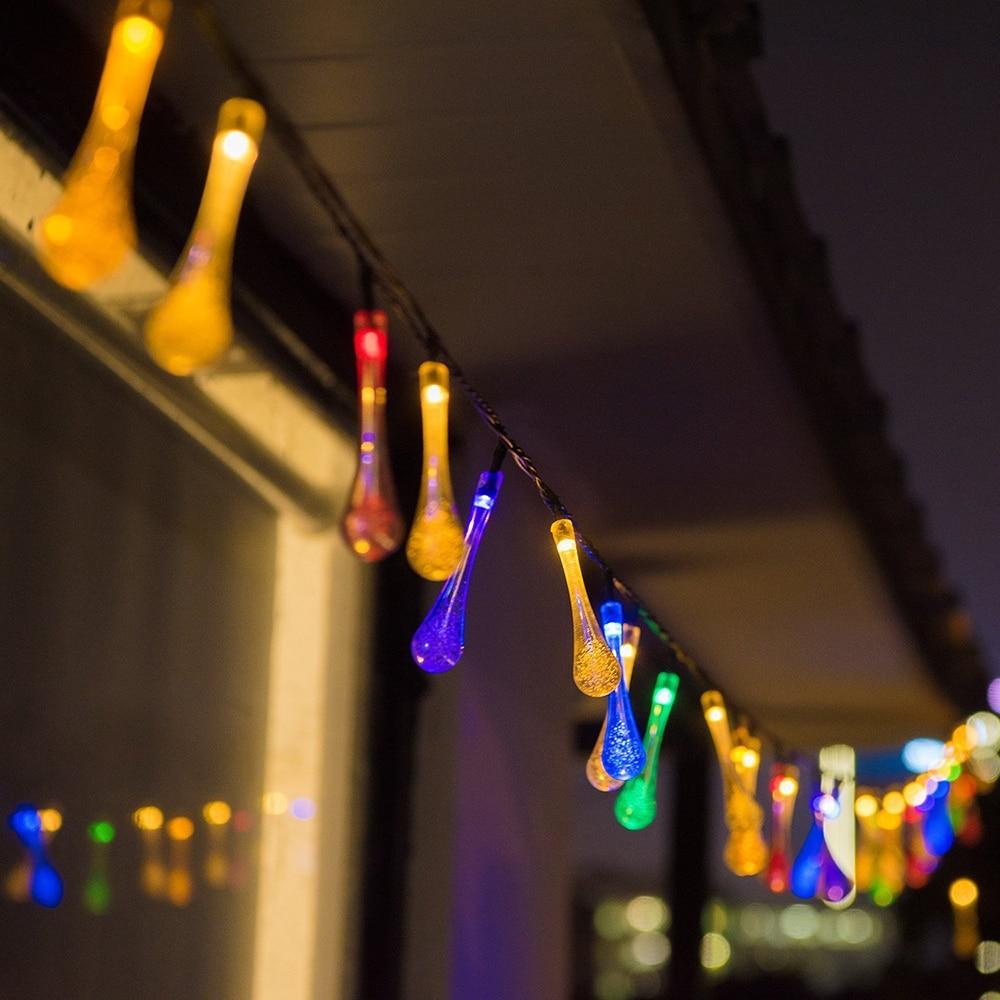 Sigrid multicolor solar droplet string lights along a balcony at night
