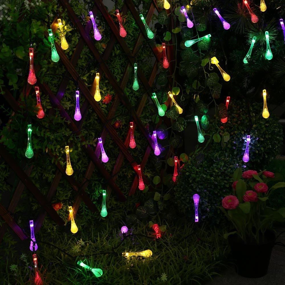 Sigrid multicolor solar droplet string lights arranged across a garden trellis