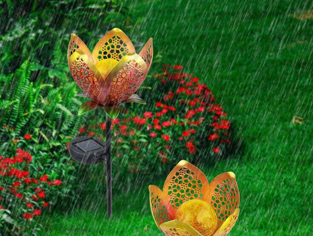 Idun gold flower stake lights in rain with solar panels and black stakes