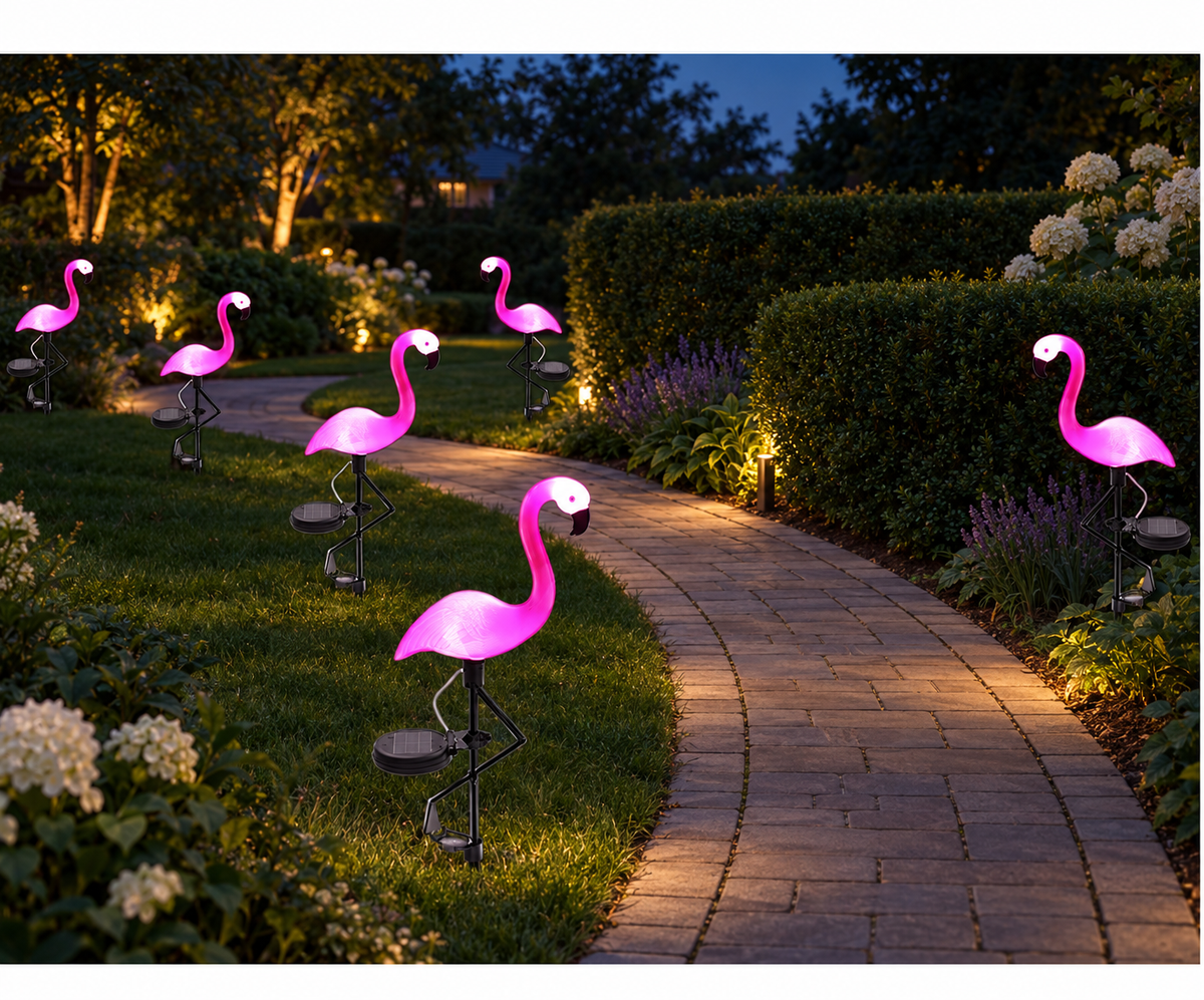 Solar flamingo garden stake lights glowing beside a curved garden path at night