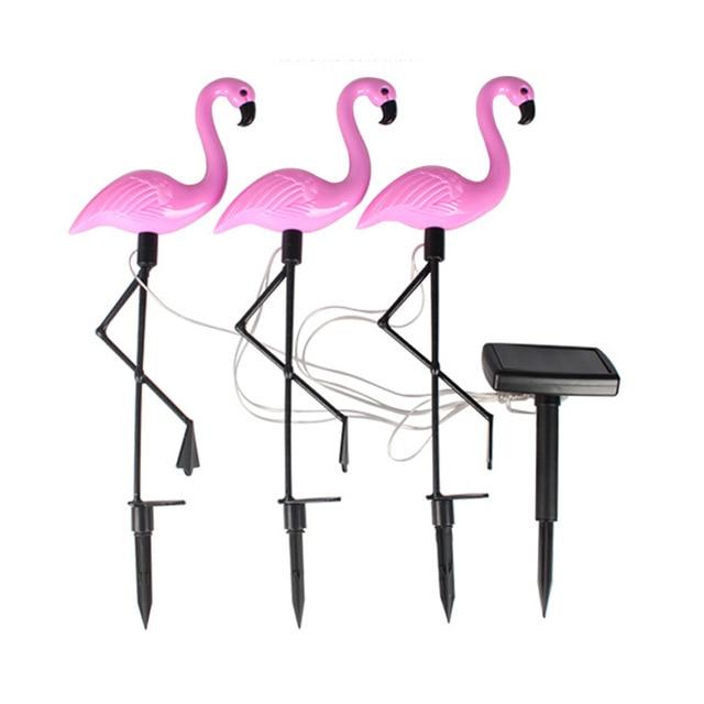Three solar flamingo garden stake lights with separate solar panel and cables