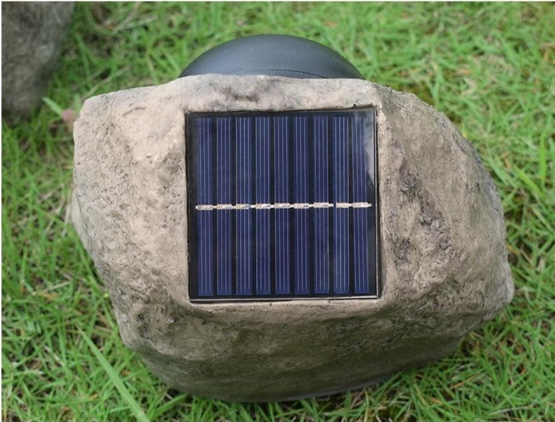 Stone-effect solar garden light top view showing the rectangular solar panel