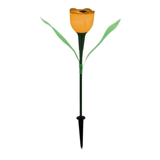 Orange solar tulip garden stake light with green leaves and black soil stake