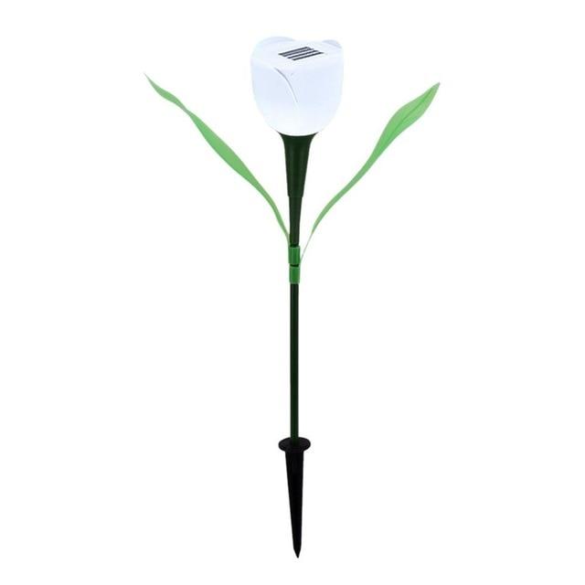 White solar tulip garden stake light with green leaves and black soil stake