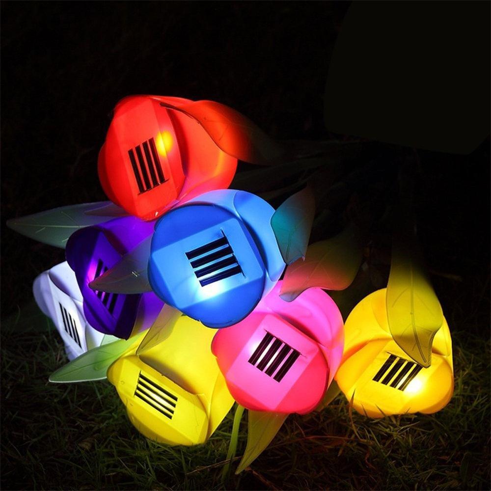Multicolor solar tulip garden stake lights viewed from above with solar panels glowing at night